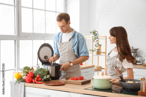 Young couple using multi co...