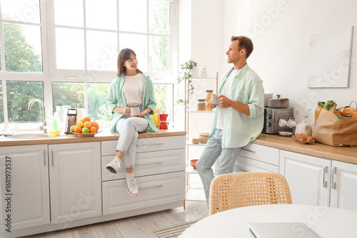 Young couple with cups of c...