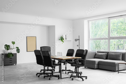 Interior of conference hall with table, lamp and sofa