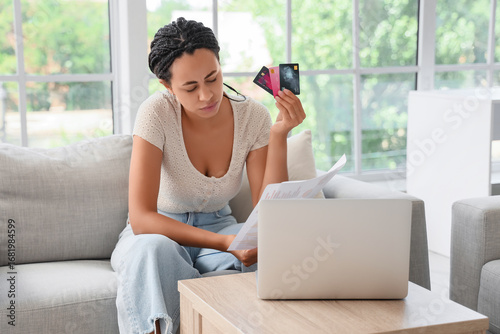 Young woman holding credit ...