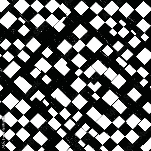 Abstract grunge pattern of fragmented white diagonal squares on a black textured surface.
