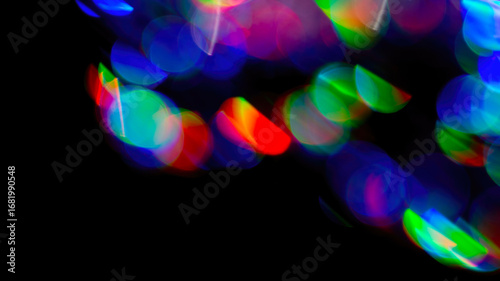 Abstract rainbow bokeh lights, colorful holographic blur on dark background, vibrant glowing texture