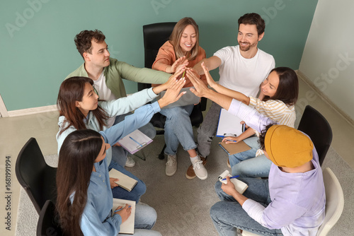 Young people putting hands ...