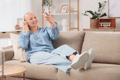 Senior woman in headphones ...
