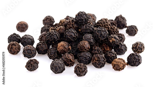 A pile of black peppercorns on a white background.  Close-up view