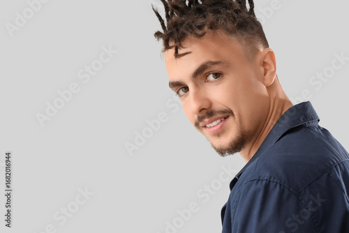 Young man with dreadlocks o...