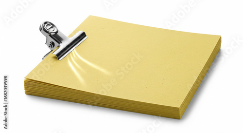 Stack of Yellow Sticky Notes with Metal Bulldog Clip on Isolated transparent background.