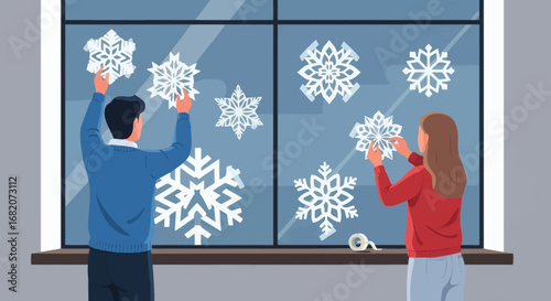 A man and a woman decorating a window with white paper snowflakes using tape showing an indoor winter activity