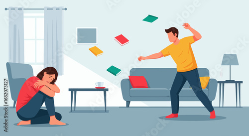 A man throws books across a living room as a woman sits huddled and distressed on the floor