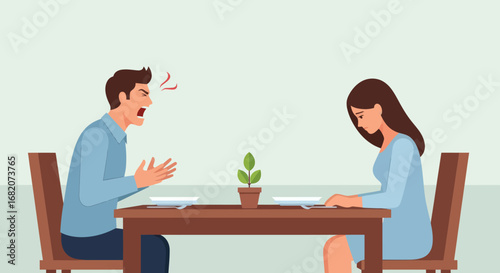 Angry man shouts at dejected woman across a dining table with empty plates and a small potted plant between them