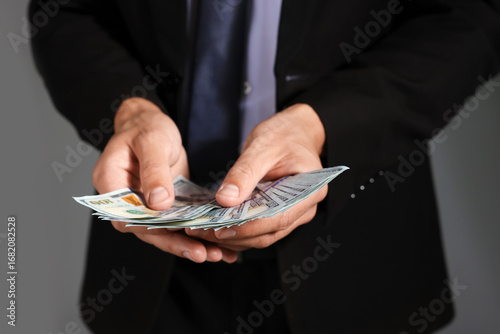 Wallpaper Mural Man with dollar bills on grey background, closeup Torontodigital.ca