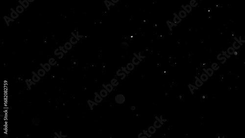 Natural Organic Dust Particles Floating On Black Background. Glittering Sparkling Particles Randomly Spin In The Air With Bokeh. Dynamic Particles With Fast And Slow Motion. Shimmering Dust In Space.	