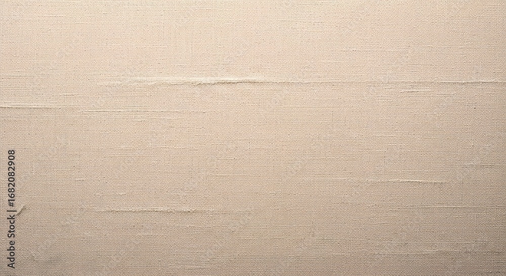 Fototapeta premium Close-up of a textured beige canvas fabric background with subtle horizontal lines and subtle wear