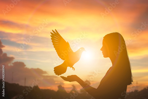Silhouette woman with flying bird