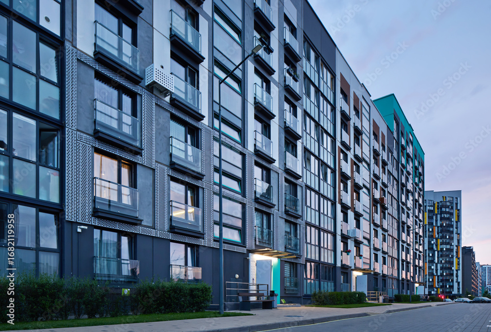Obraz premium New modern block of flats in green area at night. residential apartment with flat buildings exterior. luxury house complex. Part of City Real estate property, condo architecture. apartment