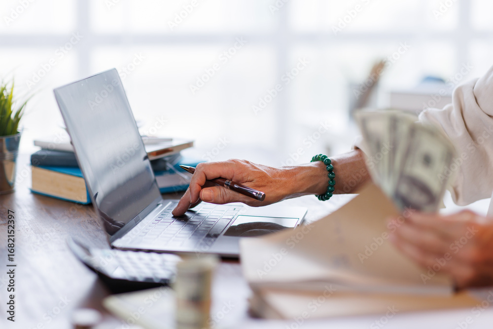 Fototapeta premium Asian male accountant or banker making money calculations. business man in workplace, Documents, tax, report for analysis Savings, finances and economy concept.