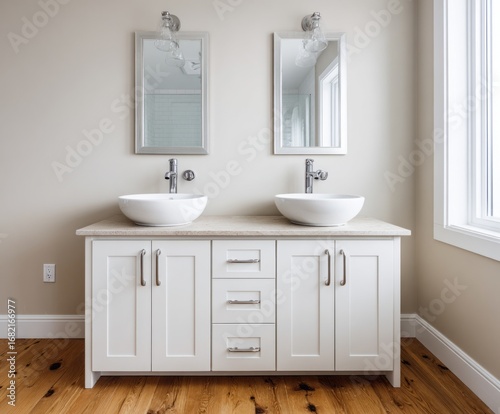 A modern bathroom vanity with double sinks  showcasing clean lines and a light beige color scheme.