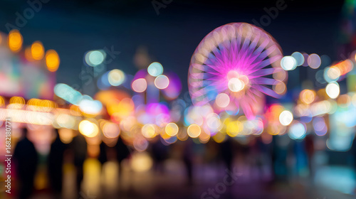 Blurred night carnival with bright ferris wheel. Perfect for festive event concepts, backgrounds, holiday celebrations, and joyful design projects.