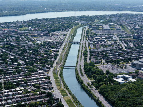 Aerial view of Verdun neighbourhood, Lachine Canal and Montreal downtown skyline in summer. g.
