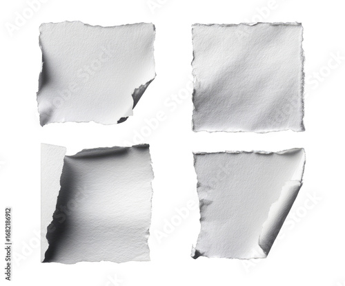 Four ripped white paper squares, angled, on black background