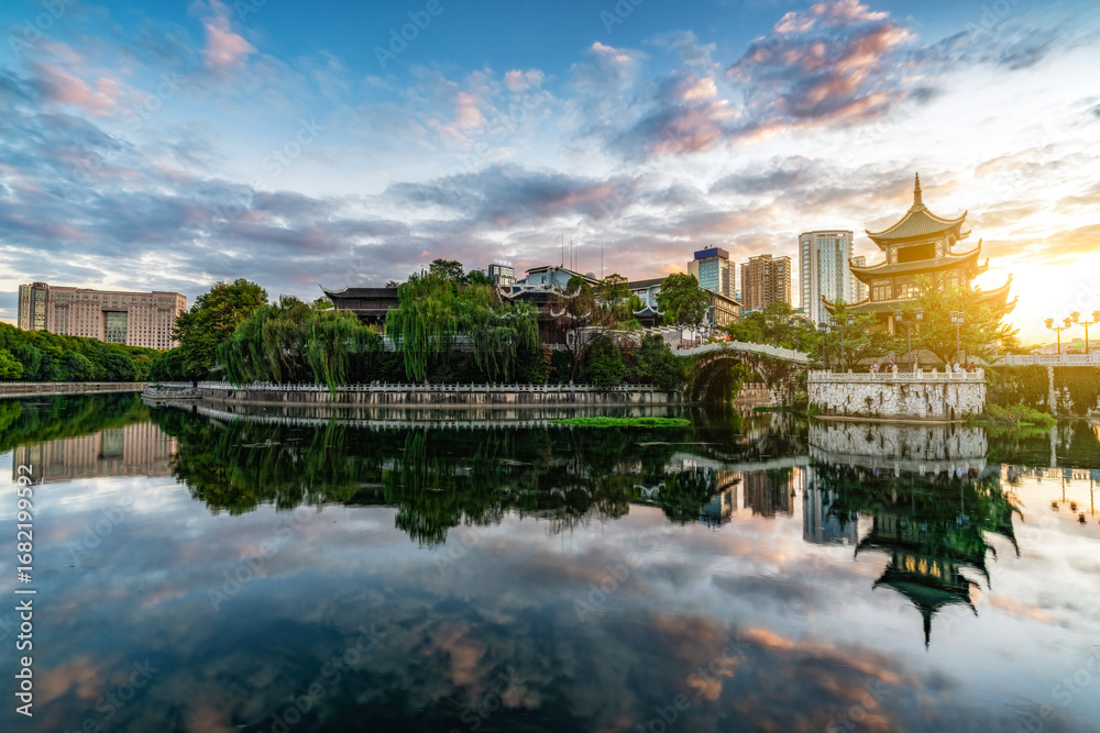 Fototapeta premium Beautiful Scenic View of Ancient Pavilion by Lake at Sunset