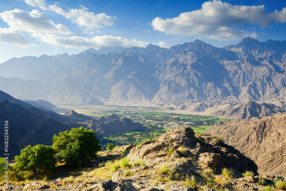 Fototapeta premium Cultivated valley with distant rocky peaks