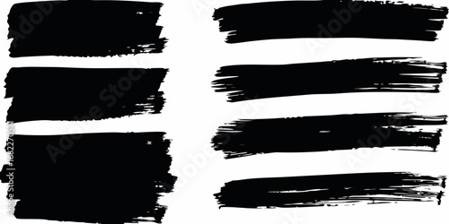 Collection of seven black brush stroke paint splatters and grunge textures on white background