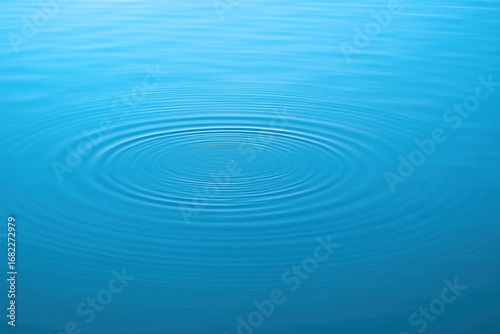 Calm water surface with circular ripple effect. Peaceful and minimal blue background ideal for aquatic, wellness, or zen-inspired themes.