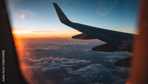 Airplane wing at sunset over clouds aerial view travel photography serene environment
