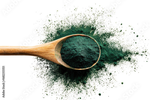 Wooden spoon filled with dark green powder, surrounded by a scattering of light powder