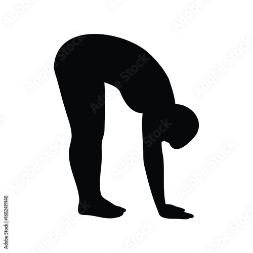Silhouette of a person in a standing forward bend yoga pose