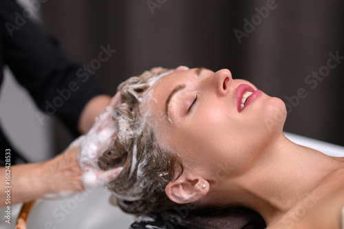 Hair washing and scalp massage in spa salon