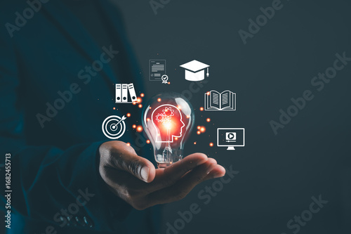 A hand holds a glowing light bulb symbolizing ideas, surrounded by icons representing education, technology, and goals.