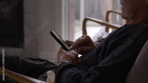 Older retired man using smartphone - tech savvy seniors  - close up on hands