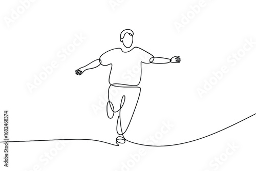 Man walking on a tightrope with arms outstretched for balance