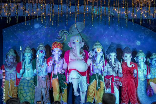 Photography Group of Ganesh idols in colorful attire, Artistic Ganesha statues in different forms, Multiple Ganesh murti display, Festival decoration with Lord Ganesha idols stock photo