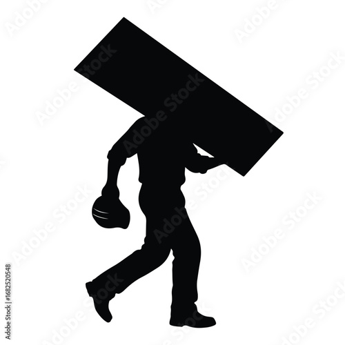 Silhouette of a construction worker carrying a large heavy plank