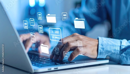 A person types on a laptop with glowing folder and document icons floating above the keyboard. A light blue background is out of focus