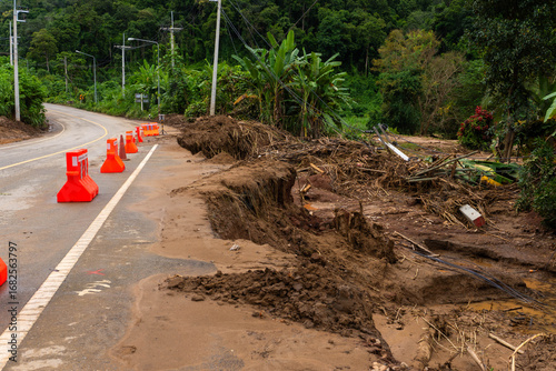 Flood-Damaged Rural Road with Barriers and Landslide Debris