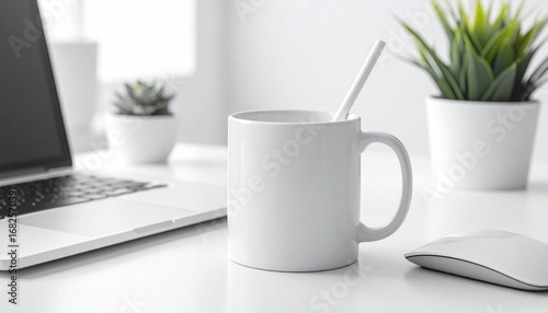 Bright, minimalist desk setup with a white mug and straw, a partially visible laptop, a mouse, and two potted plants on a white surface