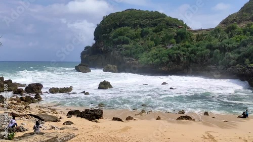 Wallpaper Mural Sembukan beach. A beautiful beach view with crashing waves, sandy beaches, and lush green cliffs under a blue sky. Torontodigital.ca