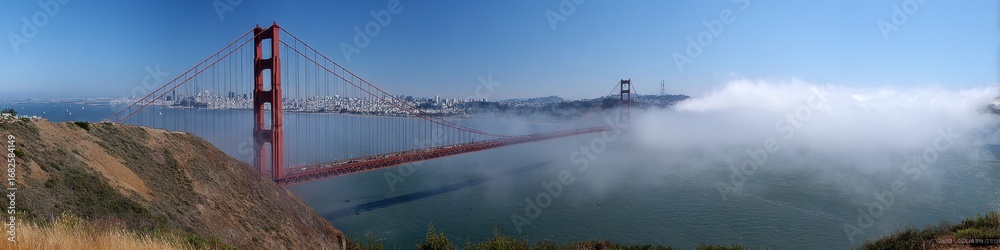 Fototapeta premium Golden Gate Foggy. Panoramic View of Golden Gate Bridge and San Francisco Cityscape with Fog
