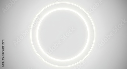 A white, glowing ring composed of two concentric circles against a soft grey background.