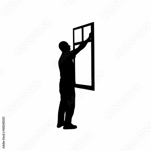 Man installing mosquito net on window silhouette