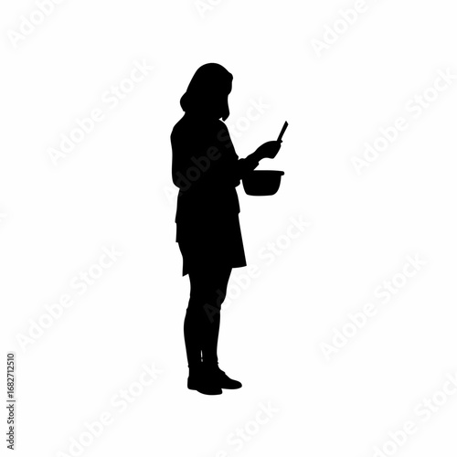 Silhouette of woman checking recipe on smartphone while cooking