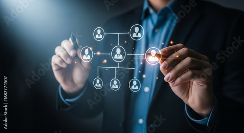 Building Connections: A close-up view of a person in a suit drawing a network diagram with a digital pen. representing the essence of teamwork and communication.