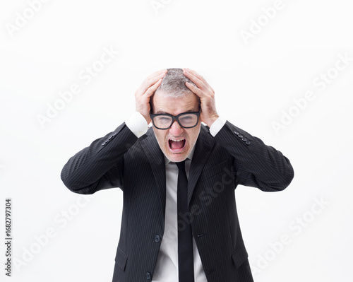 Fotografie Portrait of a middle-aged businessman screaming and despairing, half-length isol