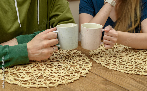 Friends, a woman and a man, drinking tea, supporting each other, chatting