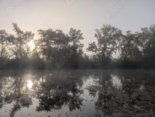 Early autumn morning with fog on the field and on the river