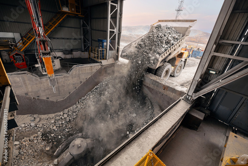 Obraz na plátně Big mining truck unloads ore for crusher, processing plant